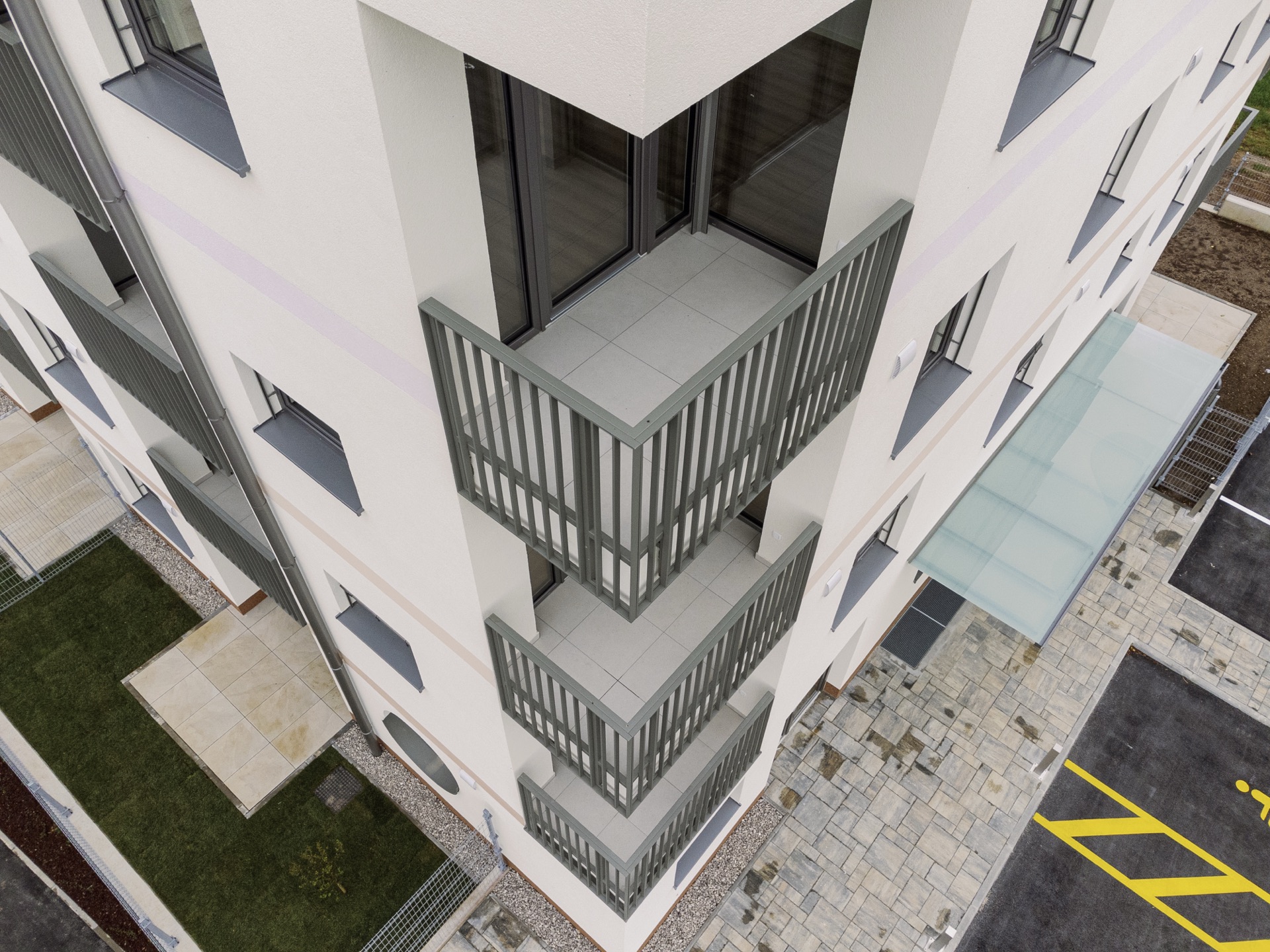 Aerial detail of balconies and paved courtyard
